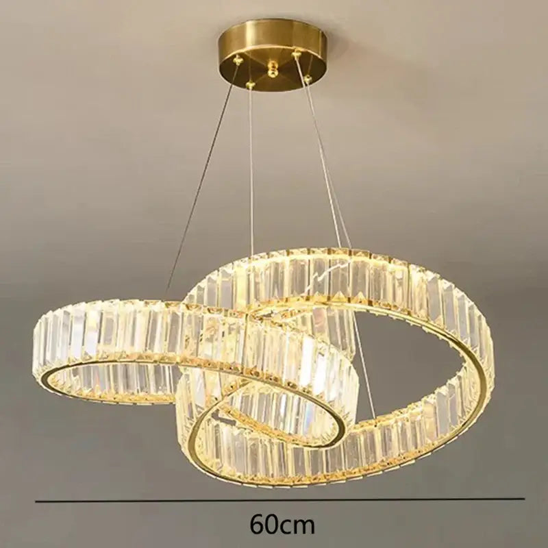 Gold-toned decorbites crystal chandelier with double rings, clear crystal facets, and integrated led lighting for modern interiors