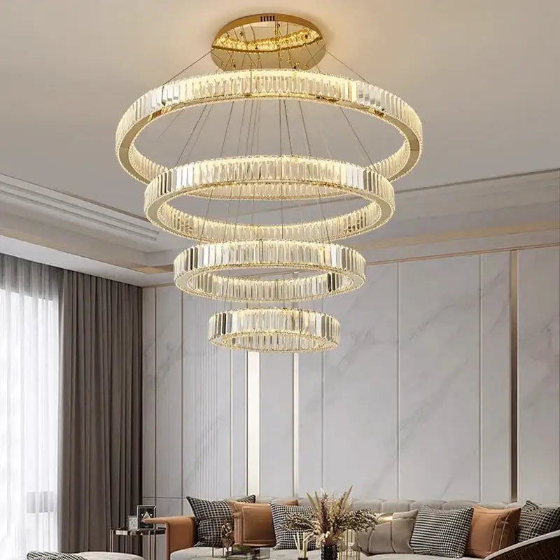 A modern decorbites crystal chandelier featuring gold-toned concentric rings with clear crystal prisms for home lighting