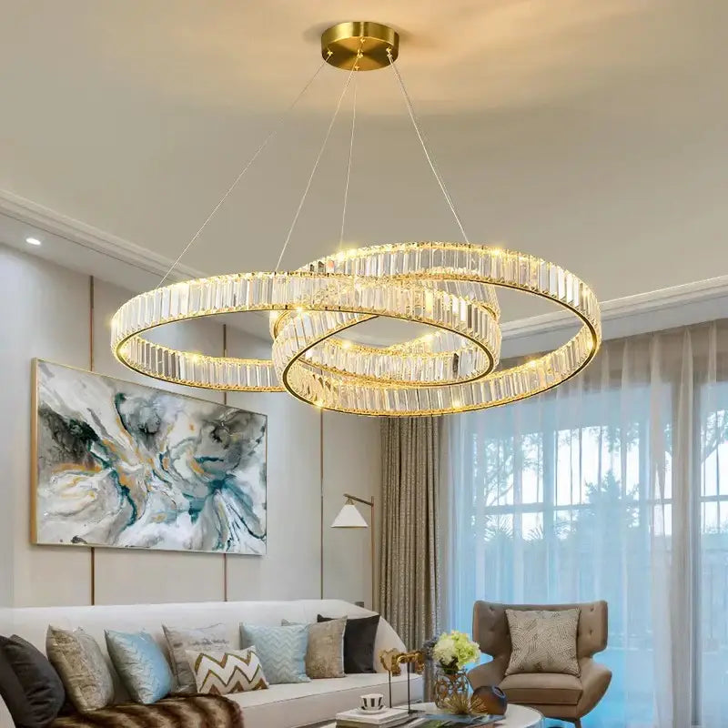 Gold-toned double-ring decorbites crystal chandelier with clear crystal accents and integrated lighting for modern interiors