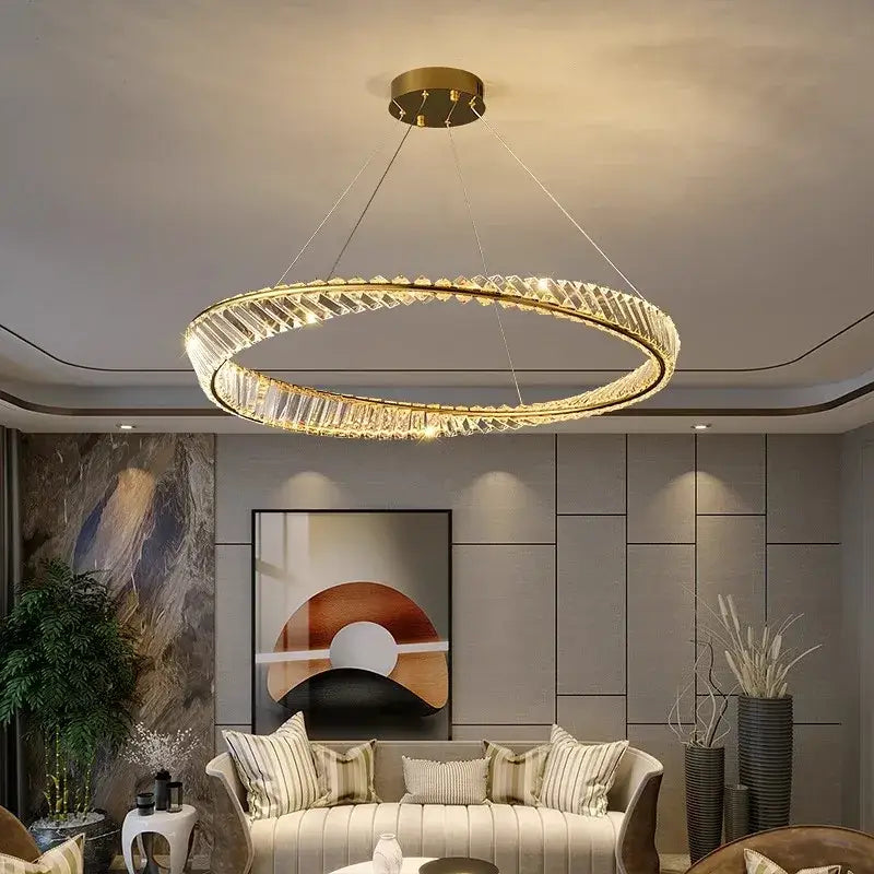 A modern gold-toned decorbites crystal chandelier with faceted crystal accents for living and dining room lighting