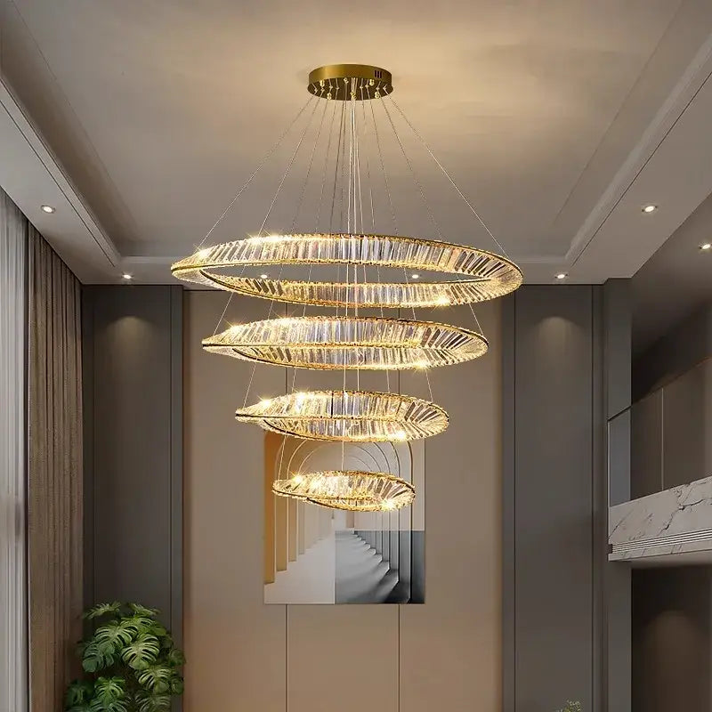 A modern decorbites crystal chandelier with multi-tiered golden rings encrusted in clear crystals for living room lighting
