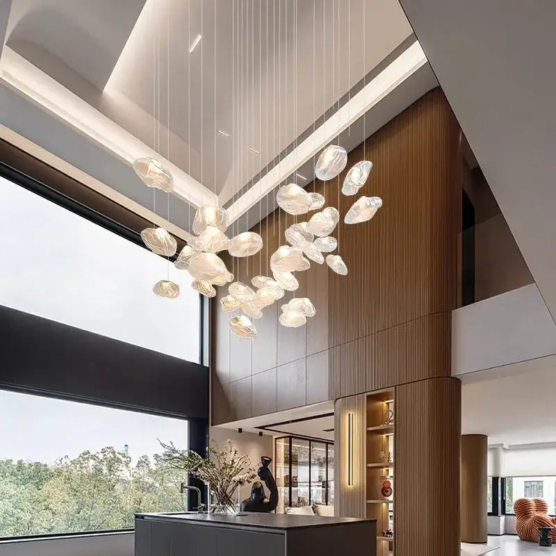 A modern cloud-shaped decorbites crystal chandelier with translucent white glass pendants for living room lighting