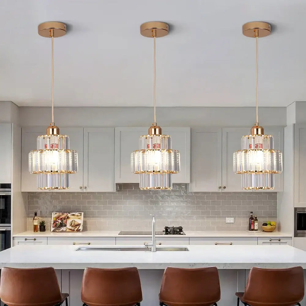 Three gold-toned decorbites crystal chandelier pendant lights with clear prism tiers for living room and hallway use