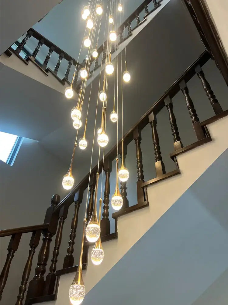 A modern decorbites crystal chandelier with gold cords and glass bulbs emitting warm light for living rooms