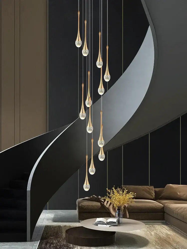 Golden teardrop-shaped decorbites crystal chandelier with clear crystal accents for modern living room and staircase lighting