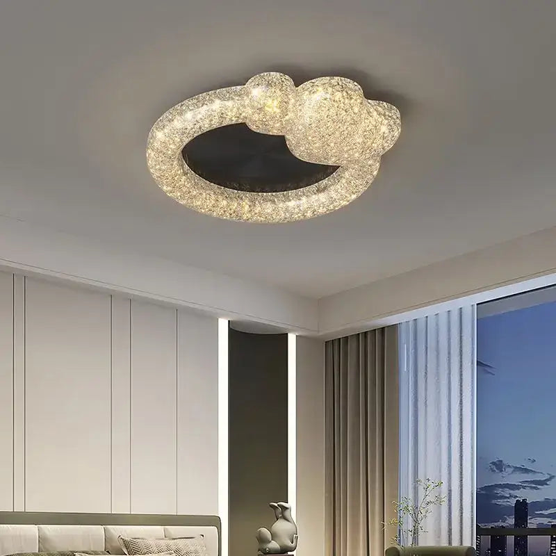 A modern circular ceiling light fixture with textured glittering gold finish and illuminated ring from decorbites crystal chandelier