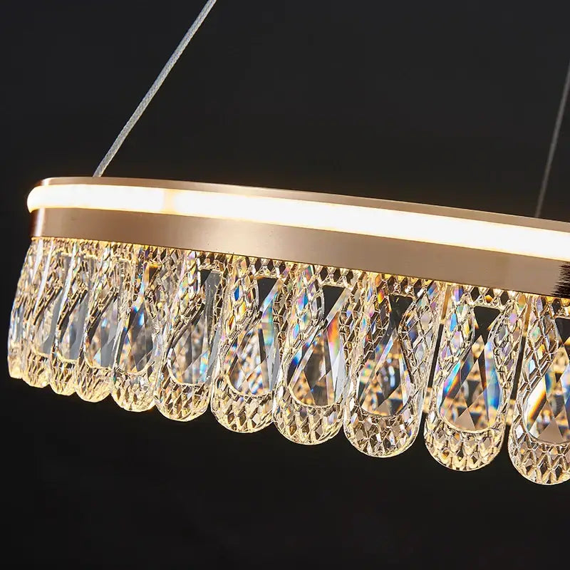 Gold-toned decorbites crystal chandelier with cascading teardrop crystal pendants for modern luxurious lighting