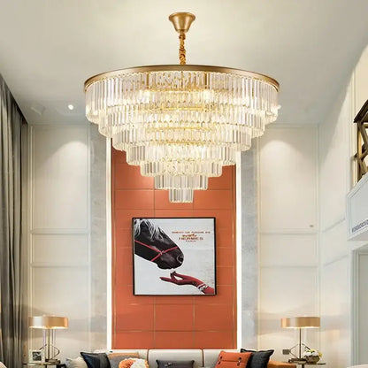 A multi-tiered decorbites crystal chandelier with cascading clear crystal rods and polished gold frame for modern home decor