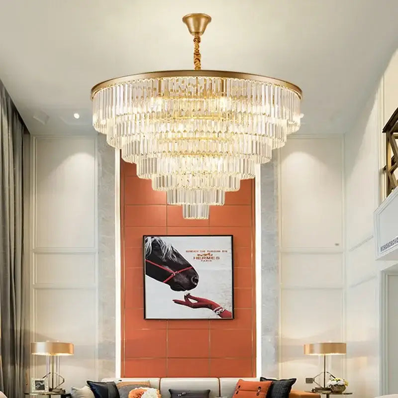 A multi-tiered decorbites crystal chandelier with cascading clear crystal rods and polished gold frame for modern home decor