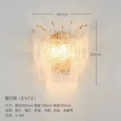 A warm glowing decorbites crystal chandelier wall lamp with textured glass and gold-toned metal accents for home decor