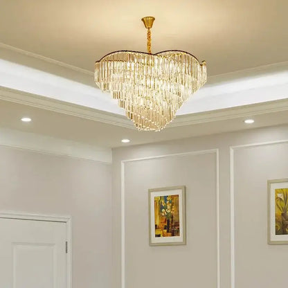 A heart-shaped decorbites crystal chandelier with cascading crystal strands and gold-toned metal frame for modern spaces