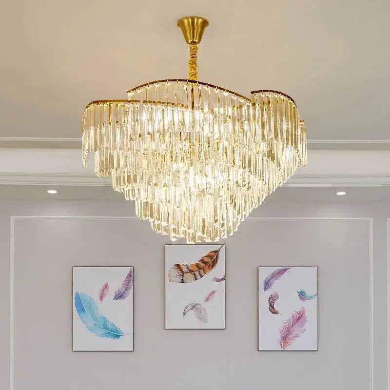 A luxurious gold-toned decorbites crystal chandelier with cascading crystal prisms for living room and bedroom use