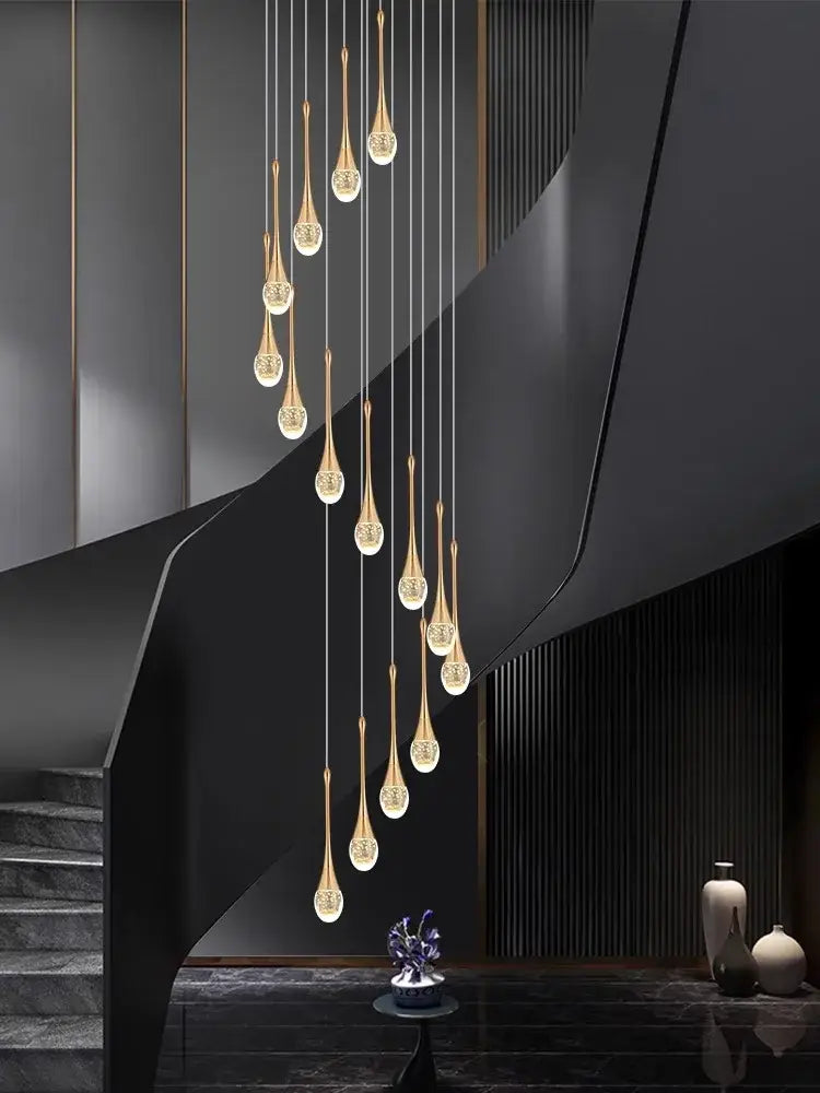 A modern gold-toned decorbites crystal chandelier pendant light with teardrop glass globes in a sleek black interior