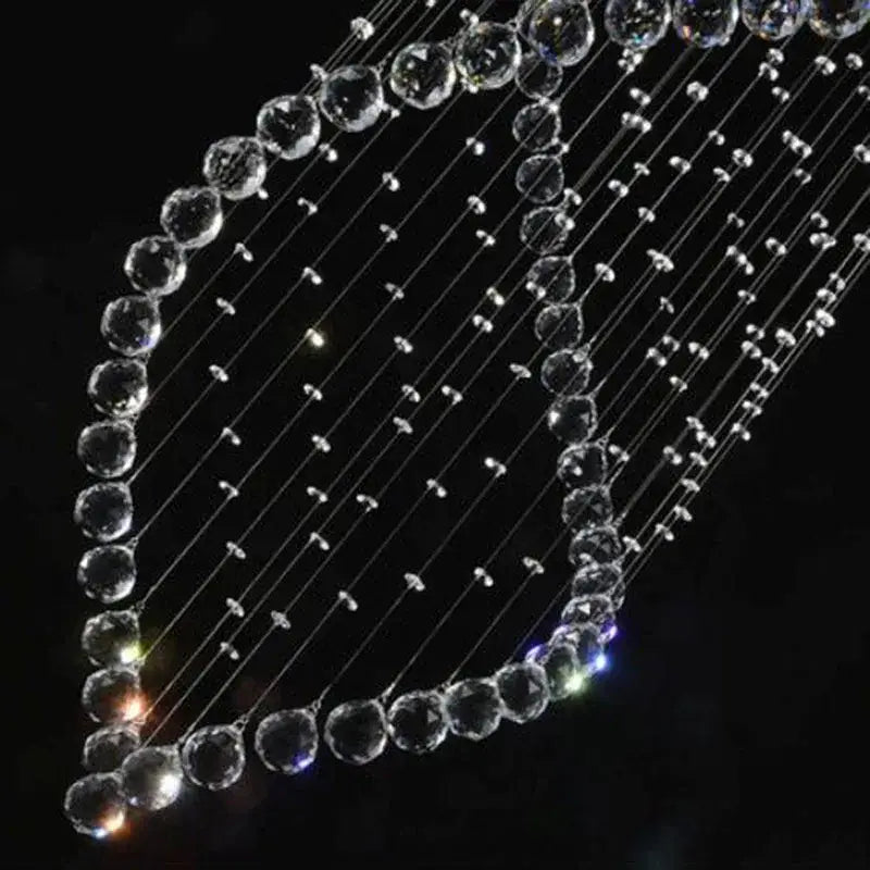 A decorbites crystal chandelier with clear faceted beads strung on wires for modern villa staircase lighting