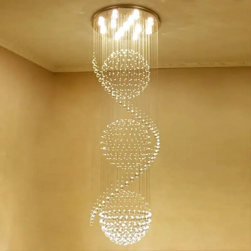A modern decorbites crystal chandelier with cascading crystal beads and circular metal frame emitting warm light