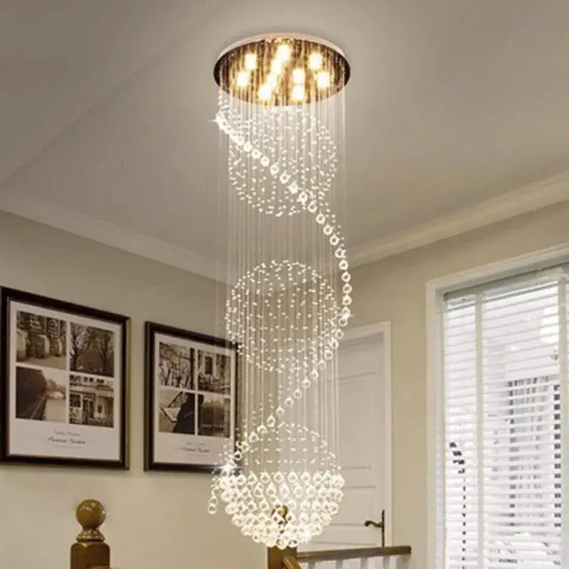 A modern decorbites crystal chandelier with cascading crystal beads and gold-toned ceiling fixture for living rooms