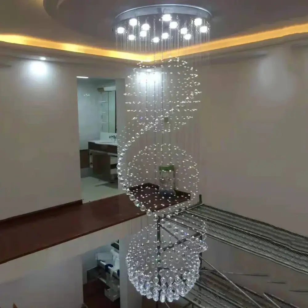 A modern decorbites crystal chandelier with cascading clear crystal beads and circular ceiling fixture for living rooms