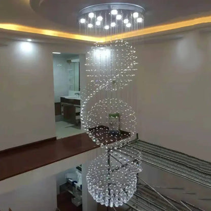 A modern decorbites crystal chandelier with cascading clear crystal beads and circular ceiling fixture for living rooms