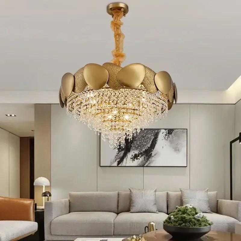 Gold-toned lotus-shaped decorbites crystal chandelier with textured metallic petals and cascading crystal droplets for living room