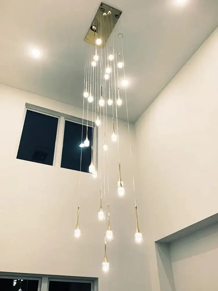 Modern decorbites crystal chandelier with multiple hanging light bulbs from a metallic rectangular ceiling fixture