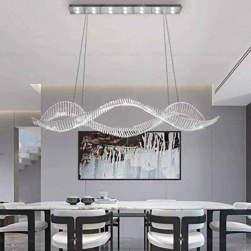 A modern wave-shaped decorbites crystal chandelier with sleek silver metal frame and hanging led lights for luxury spaces