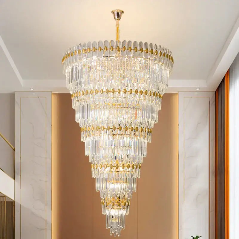 A decorbites crystal chandelier featuring multi-tiered gold accents and cascading clear glass prisms for modern luxury