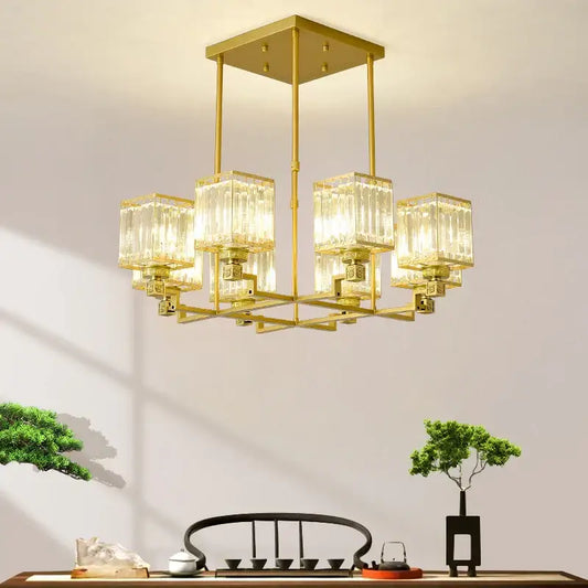 Gold-toned decorbites crystal chandelier with clear ribbed glass cubes suspended from a square frame for luxury lighting