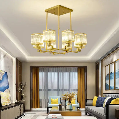 Gold-toned decorbites crystal chandelier with rectangular crystal glass shades and geometric metal frame for modern luxury lighting