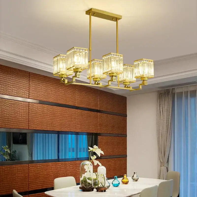 Gold-toned decorbites crystal chandelier with multiple clear glass cube shades for modern luxury lighting