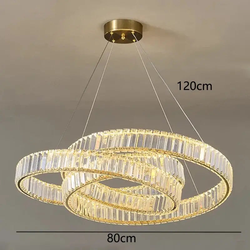 DecorBites crystal chandelier with three interlocking rings, clear crystal facets, and warm gold-toned metal frame for modern rooms