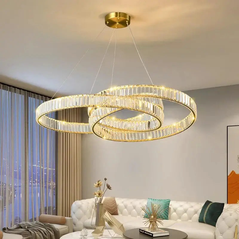 Gold-toned double-ring decorbites crystal chandelier with clear crystal accents for modern living and dining rooms