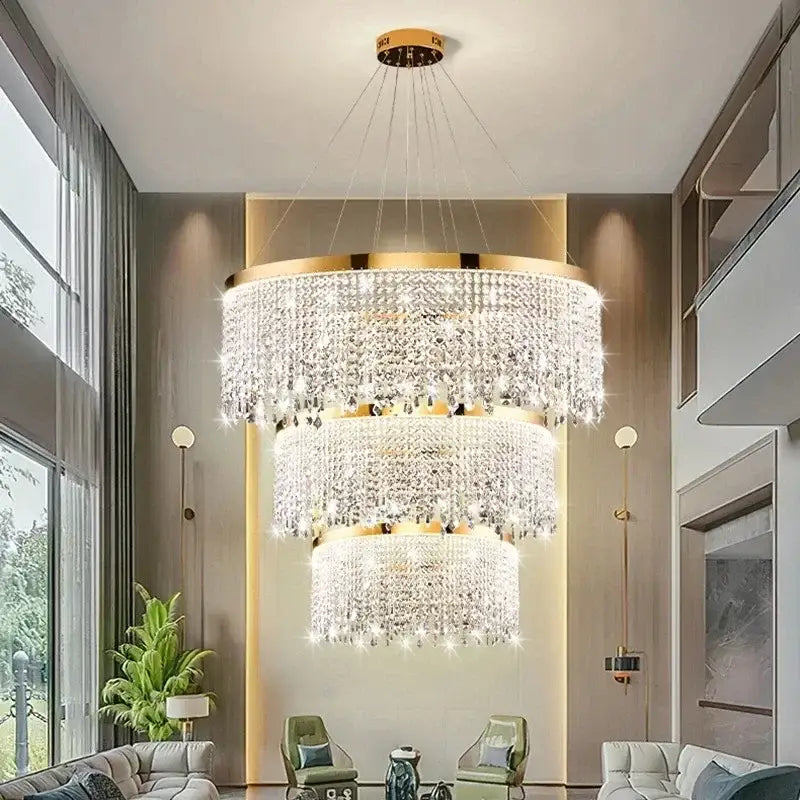 A multi-tiered decorbites crystal chandelier with gold metal accents and clear crystals for living and dining rooms
