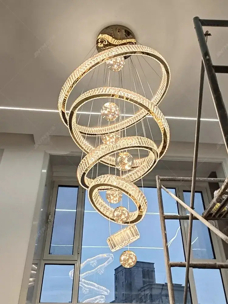 Decorbites crystal chandelier featuring a golden spiral design with crystal accents and embedded lighting for elegant interiors
