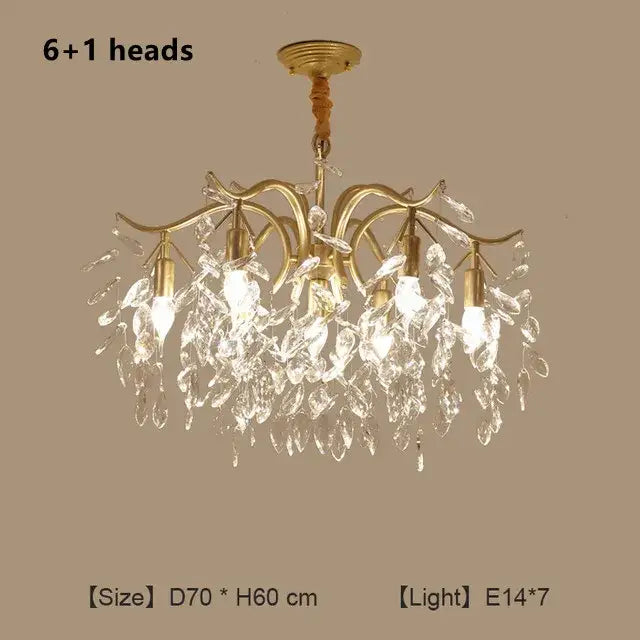 Gold-toned decorbites crystal chandelier with six illuminated heads and cascading clear crystal droplets for modern luxe lighting