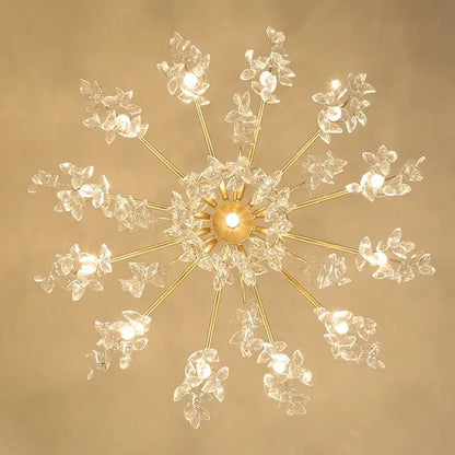 A radiant gold-toned decorbites crystal chandelier with delicate crystal flower clusters for living room and bedroom