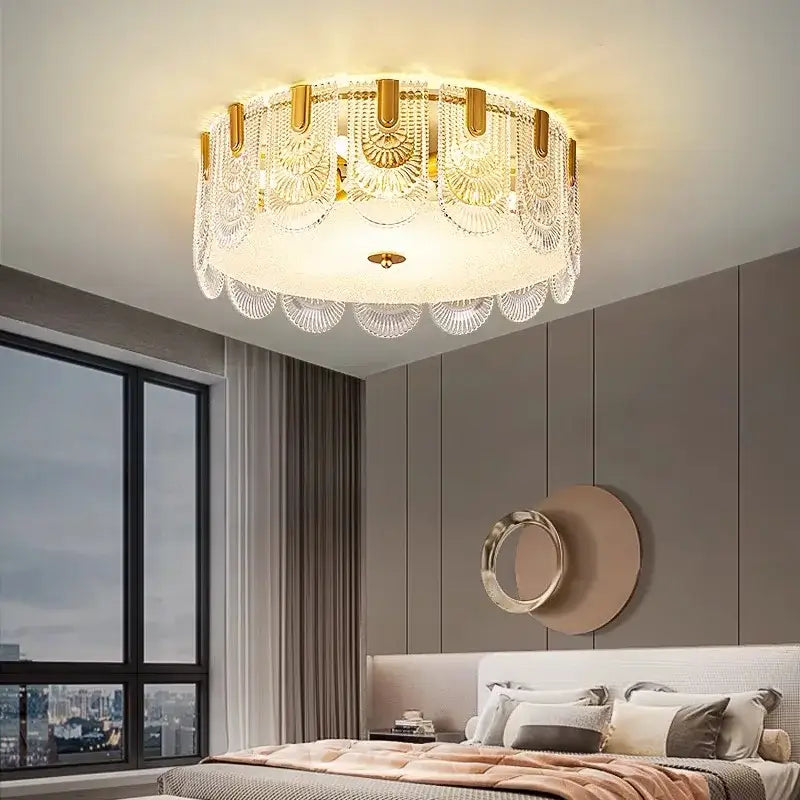 Gold-toned decorbites crystal chandelier with intricate crystal fan-shaped embellishments and frosted glass diffuser