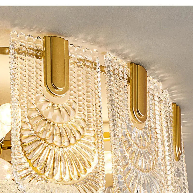 Gold-toned and clear glass decorbites crystal chandelier with textured beaded design for living room or bedroom lighting