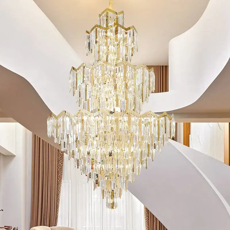 A multi-tiered decorbites crystal chandelier with gold metal frames and clear prisms for modern luxury villas and hotels