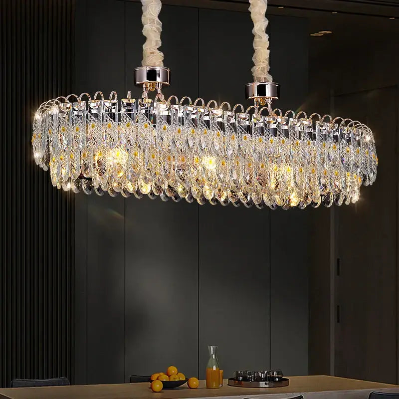 A modern decorbites crystal chandelier with cascading crystal droplets and chrome accents suspended by white cords