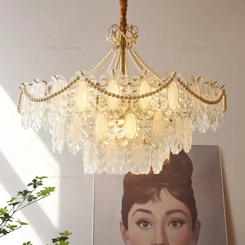 DecorBites crystal chandelier with gold-toned metal, pearl-like beads, and oval glass panels for modern luxury lighting
