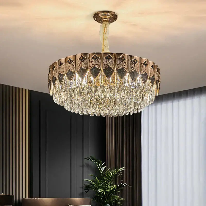 A luxurious gold-toned decorbites crystal chandelier with geometric cutouts and cascading clear crystal droplets