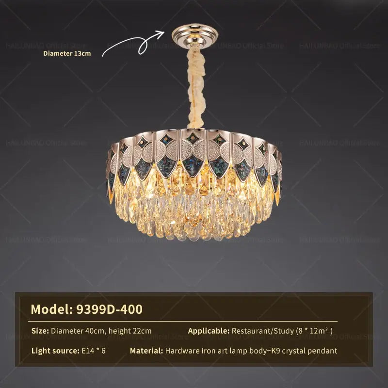 A decorbites crystal chandelier with polished brass body, dark blue and gold mosaic panels, and cascading k9 crystals