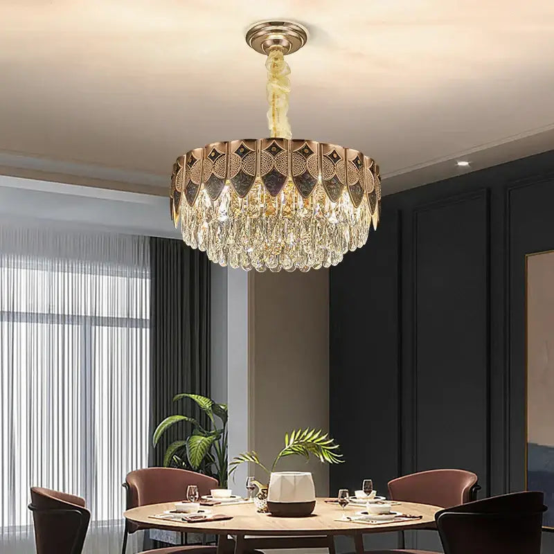 Gold-toned decorbites crystal chandelier with intricate geometric patterns and cascading crystal droplets for luxury decor