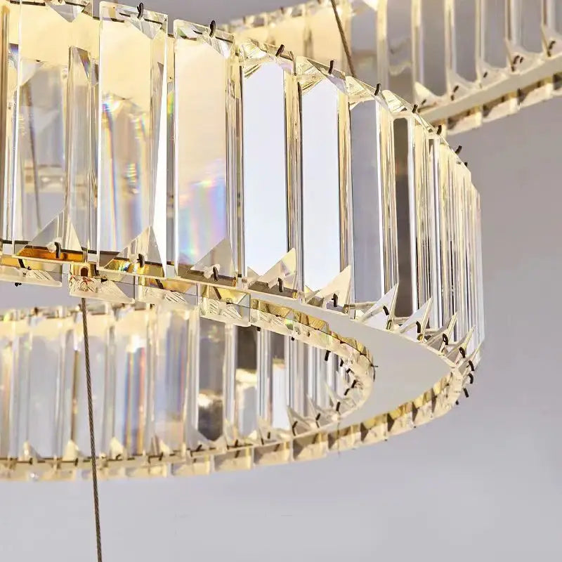 Modern decorbites crystal chandelier with double-tier clear crystal prisms and gold-toned accents for luxury lighting