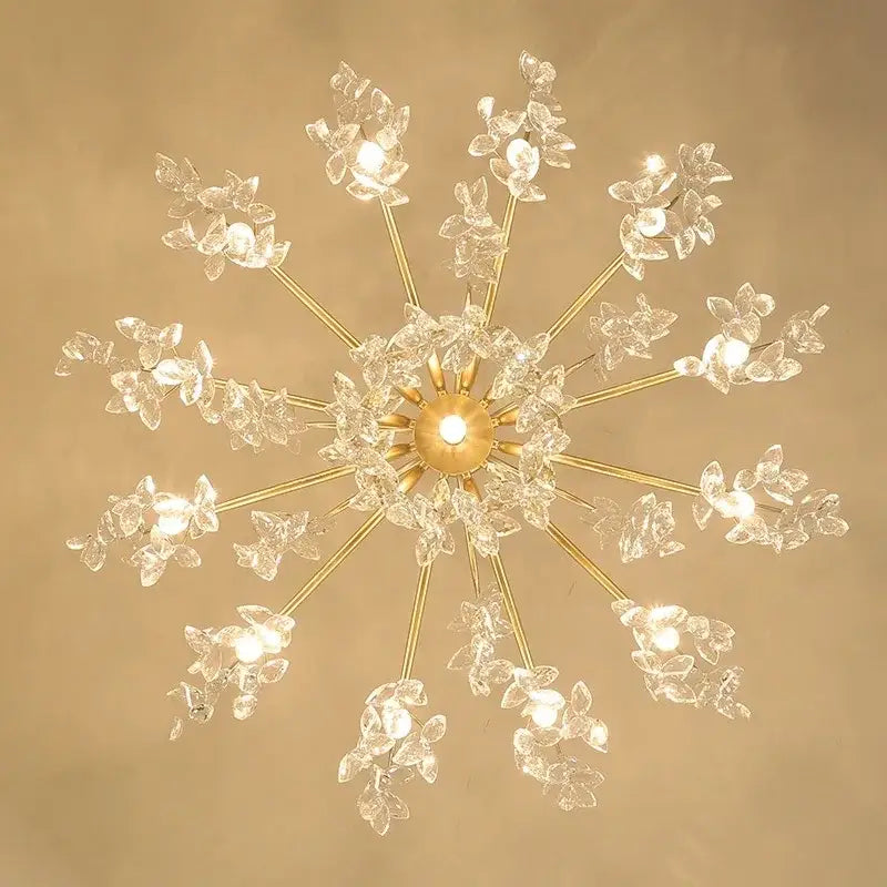 A radiant gold-toned decorbites crystal chandelier with delicate crystal flower clusters for living room and bedroom lighting