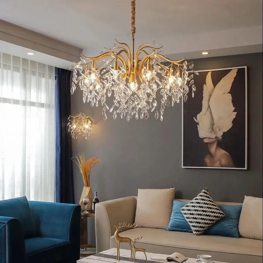 Gold-toned decorbites crystal chandelier with intricate branching arms and cascading clear crystal droplets for living spaces