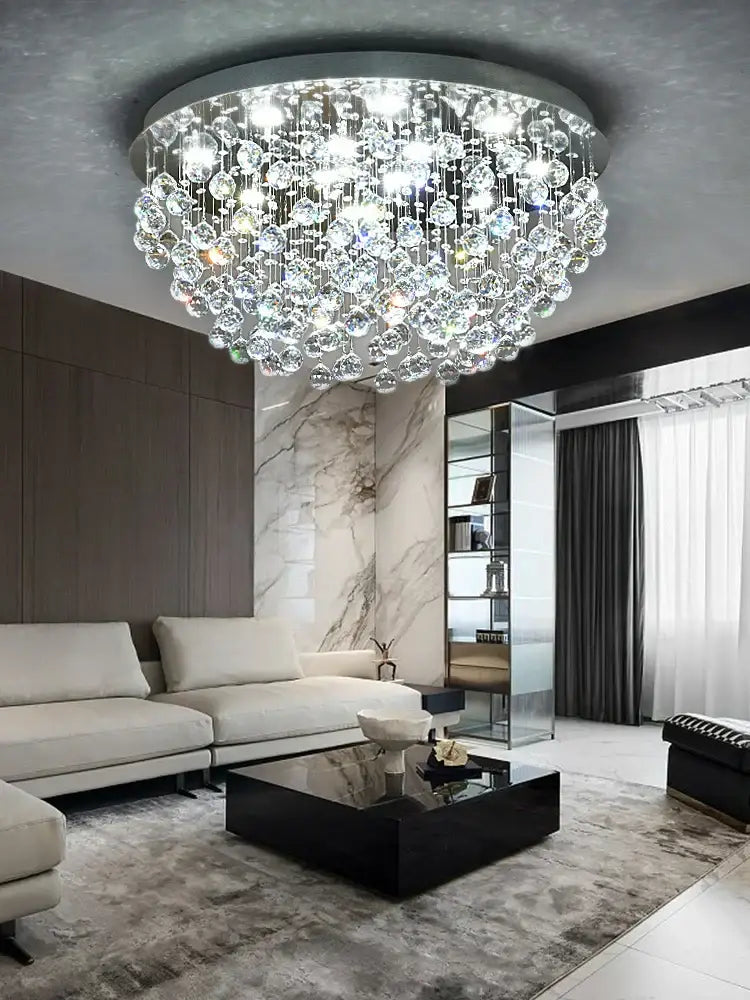 Decorbites crystal chandelier featuring a dazzling circular design with clear crystal droplets and a metallic frame for modern luxury
