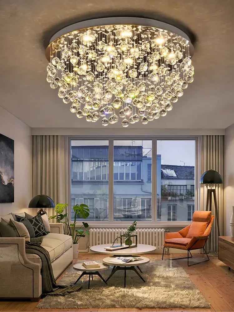 A decorbites crystal chandelier with a metallic frame and dangling glass orbs for modern luxury lighting