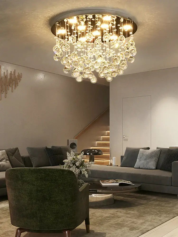 Decorbites crystal chandelier featuring a circular design with cascading crystal droplets and warm glowing lights for living rooms and bedrooms