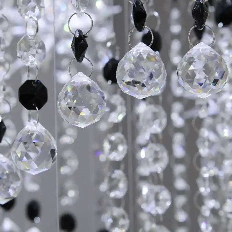 Clear faceted crystal beads with black octagonal accents hang in elegant strands on decorbites crystal chandelier